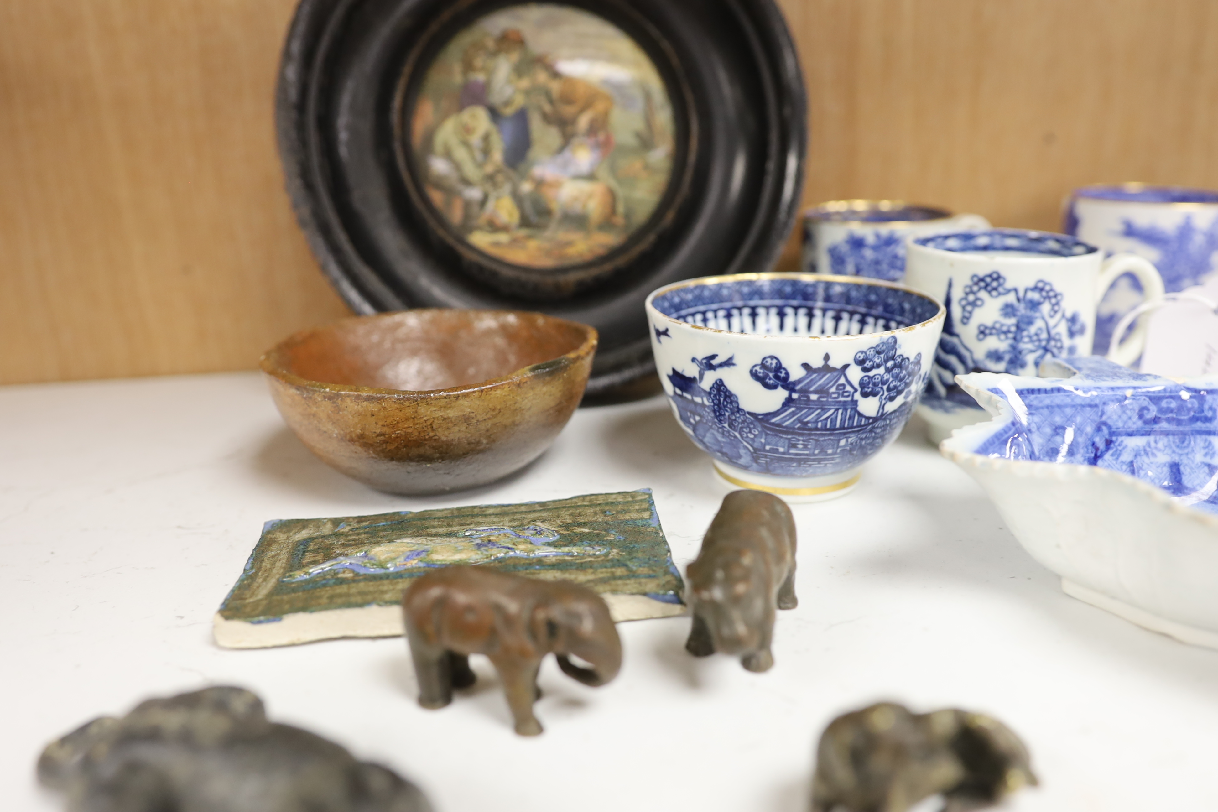 An early 20th century Viennese cold painted bronze figure of an African grey parrot, two 18th century English coffee cups, a leaf shape pickle dish, Victorian pot lid, other metal animal figures, a Japanese small carved